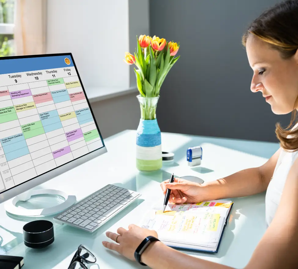 Picture of a virtual assistant sitting at her desk working on client's to-do list.